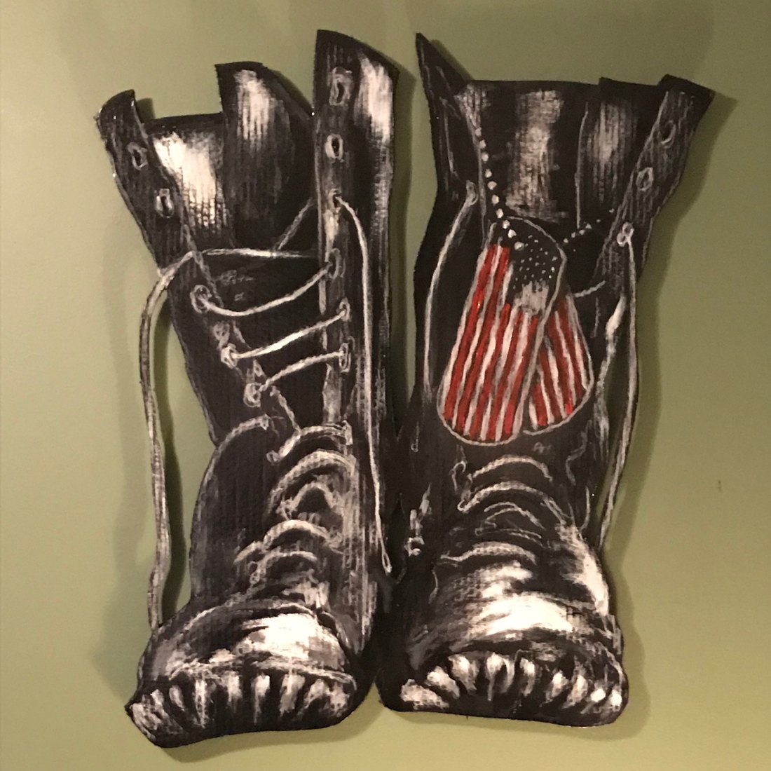 Hand-cut and hand-painted Vietnam Memorial boots, a pair of combat boots