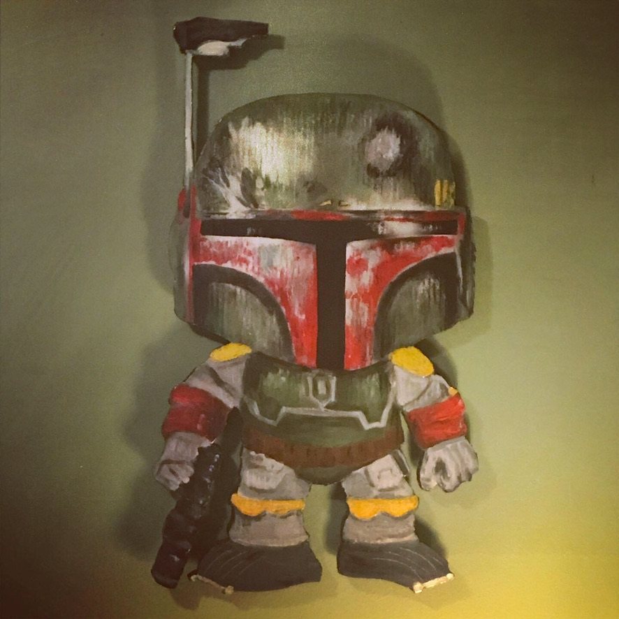 Hand-cut and hand-painted Funko Pop style Boba Fett in battered green and red armor holding a blaster, on a green wall