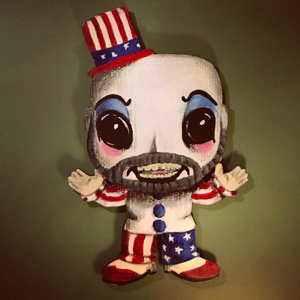 Hand-cut and hand-painted Funko Pop style Captain Spaulding in a stars and stripes top hat with a gray beard, clown makeup and an American flag outfit, on a green wall