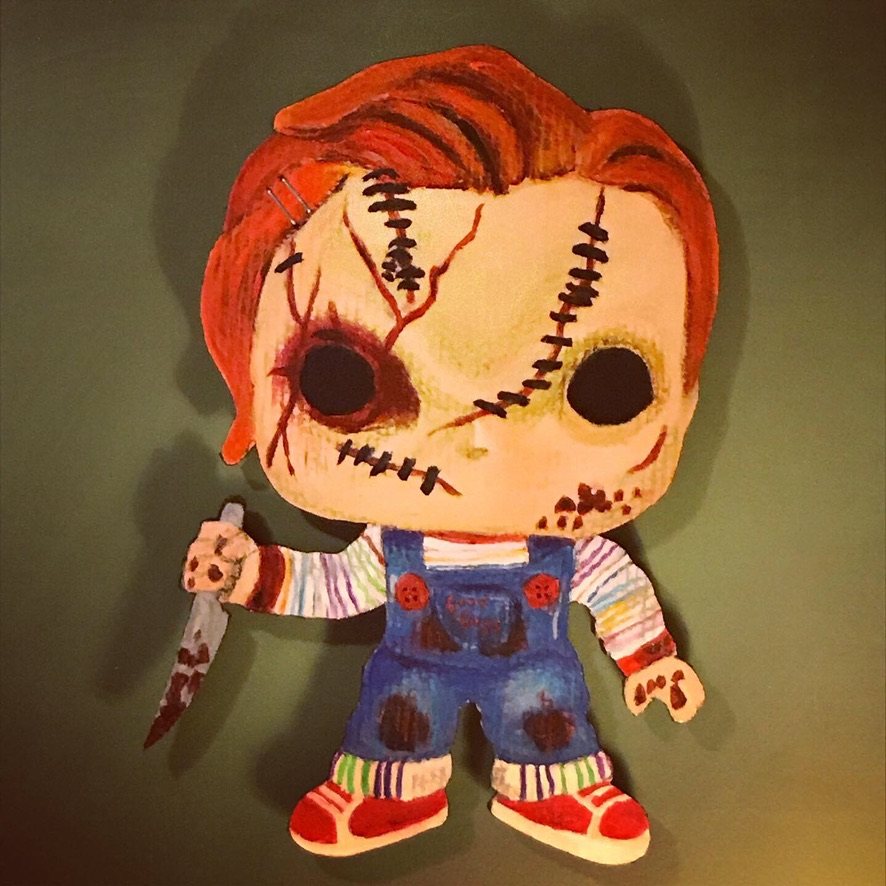Hand-cut and hand-painted Funko Pop style Chucky with stitched scars, red hair, striped shirt and overalls, holding a bloody knife, on a green wall