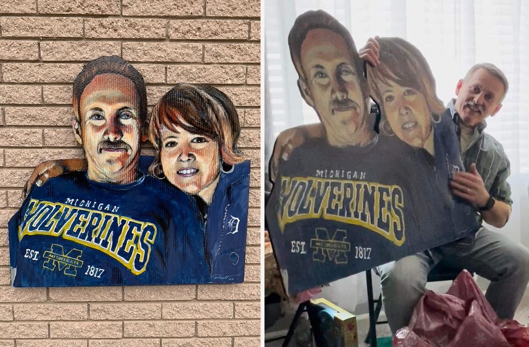 Hand-cut and hand-painted double portrait of a couple in Michigan Wolverines and Detroit Tigers clothing: on a brick wall, and held by the customer