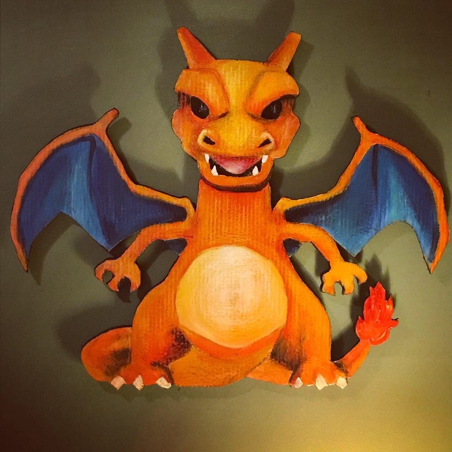 Hand-cut and hand-painted Charizard Pokémon cardboard cutout in orange with blue wings
